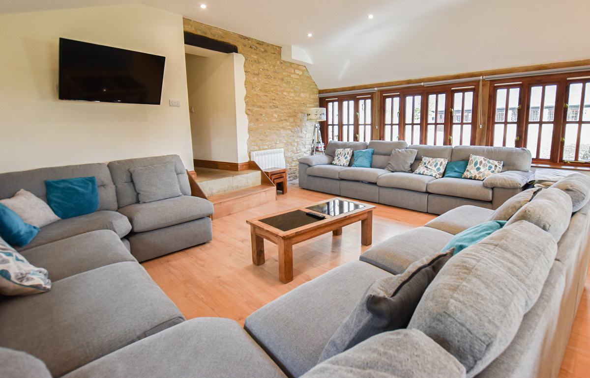 Sitting room with HDTV, oak flooring and digital electric heating.
